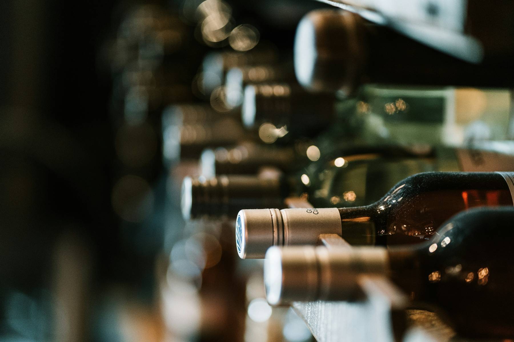 Labelled bottles on a winery rack